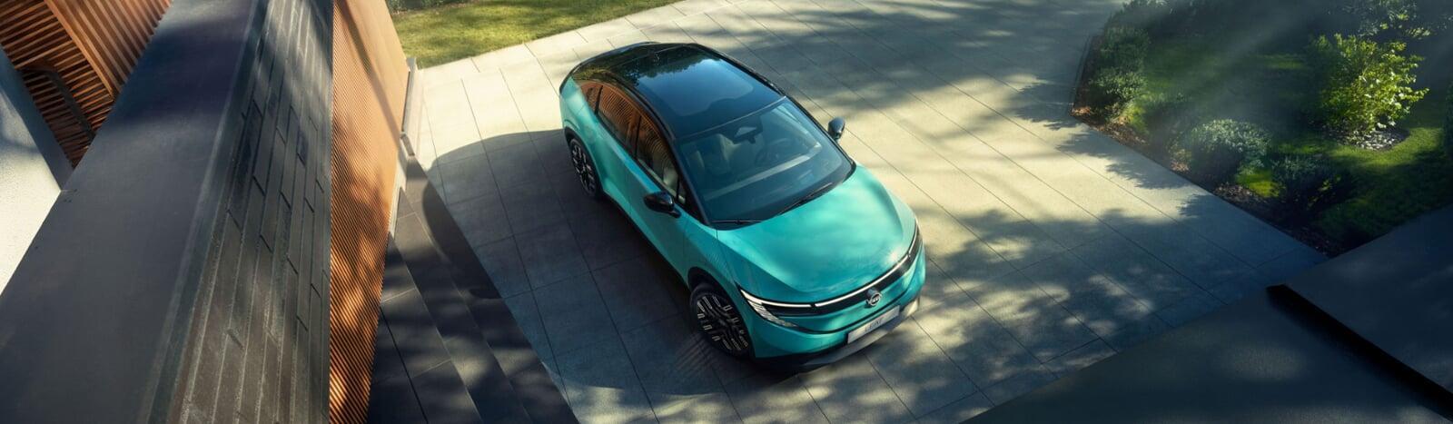 Vista superior do novo Nissan LEAF, em azul teal, com foco para o teto panorâmico com função de escurecimento. 